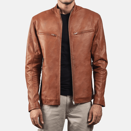 A man wearing a brown leather jacket with a mandarin collar, zipper pockets, and embroidered leather graphics on the arms and back.